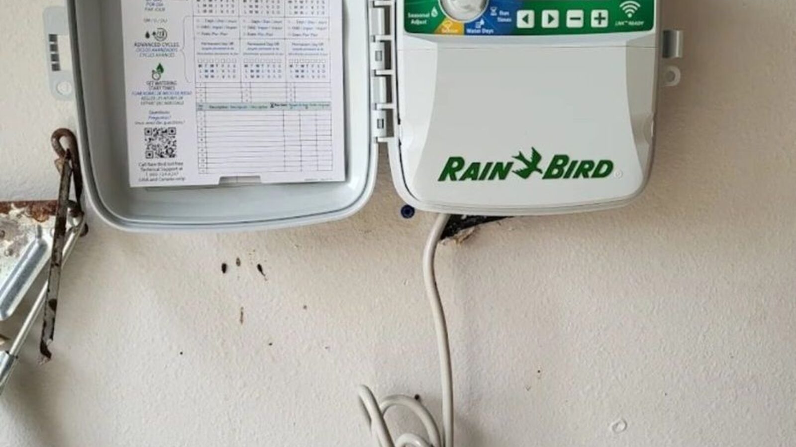 Wall-mounted irrigation controller with the zone schedule displayed