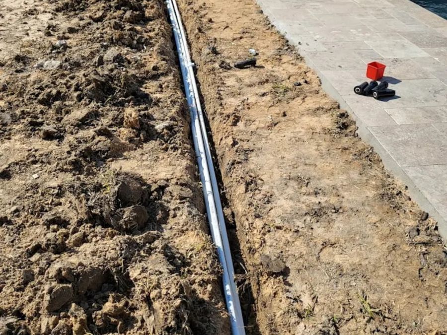 New irrigation line laid in a fresh trench